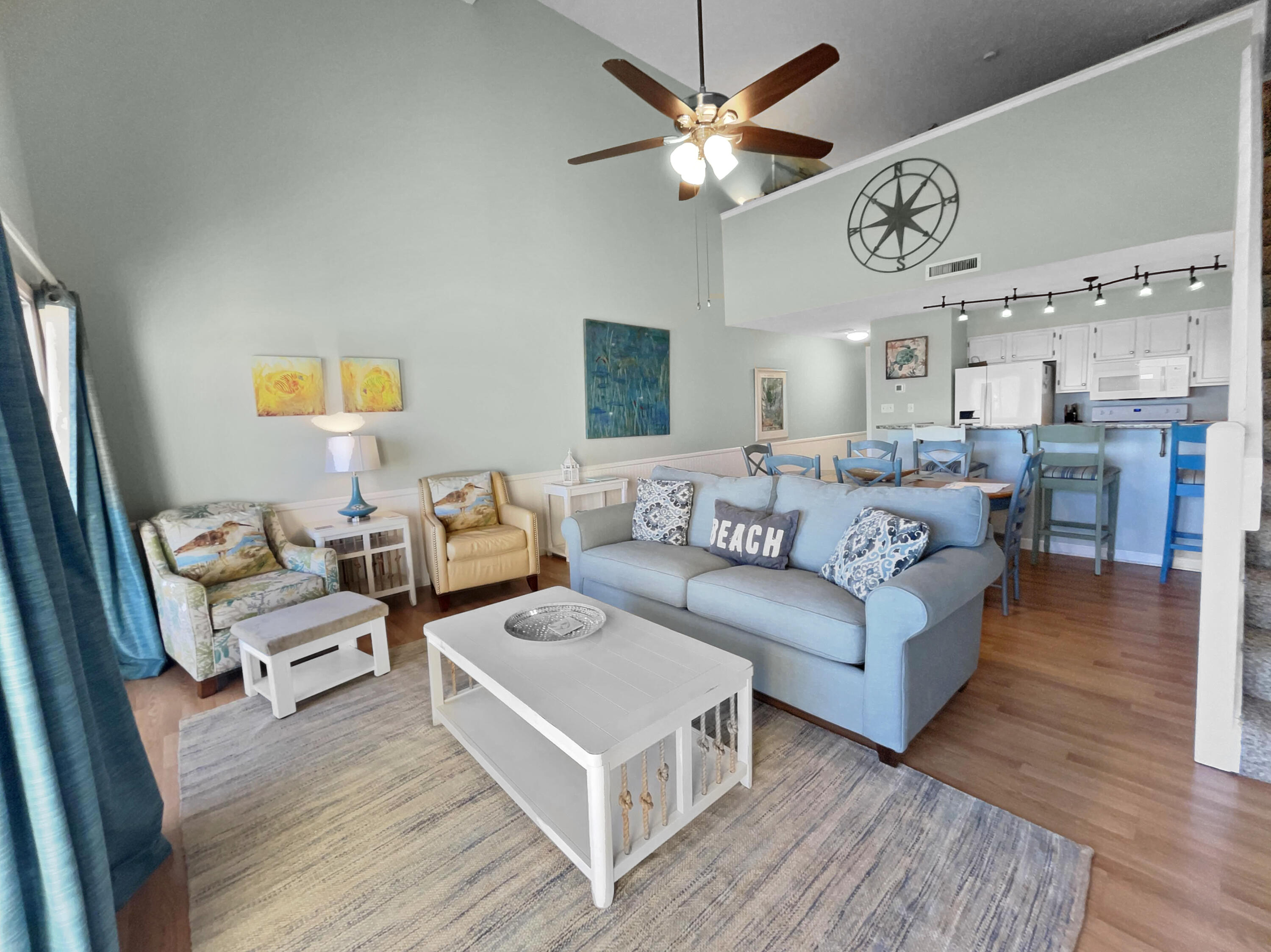 595 Eastern Lake Road, Unit 213 Santa Rosa Beach, FL 32459 - Photo 8 of 18 a living room with furniture a large window and a chandelier