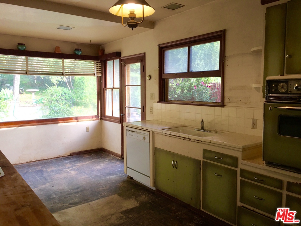 1065 Old Mill Road Pasadena, CA 91108 - Photo 4 of 7 a kitchen with a window a sink and cabinets
