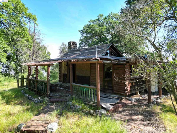 a view of a house with backyard porch and sitting area