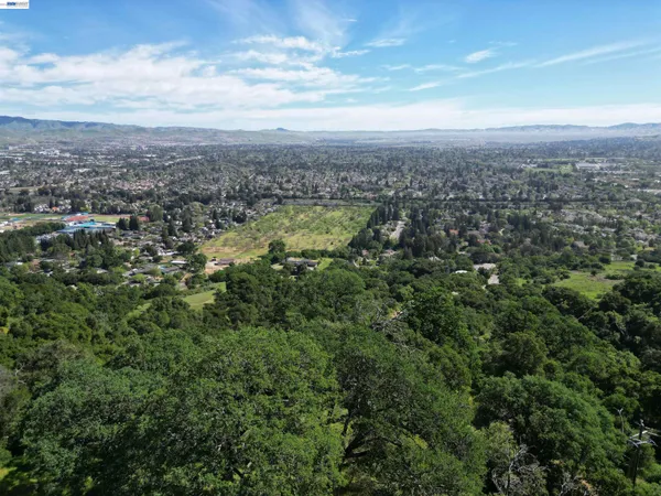 an aerial view of residential houses with outdoor space and mountain view