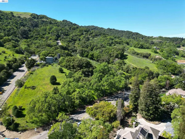 an aerial view of a house with a yard