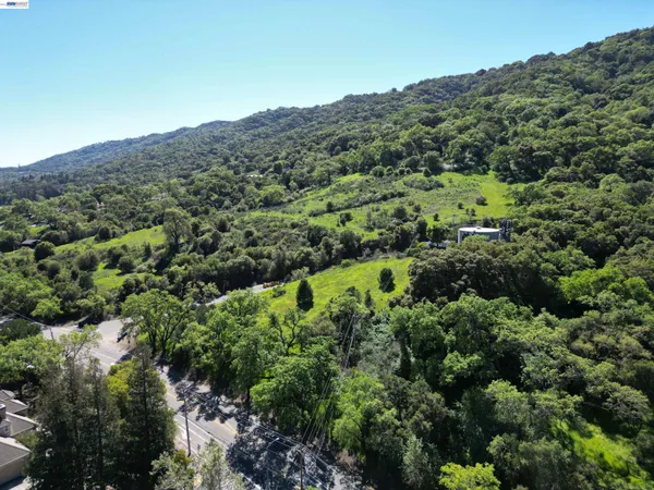 a view of house with swimming pool and a yard