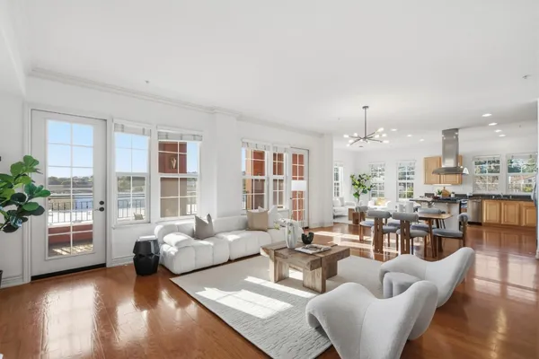a living room with furniture and large windows