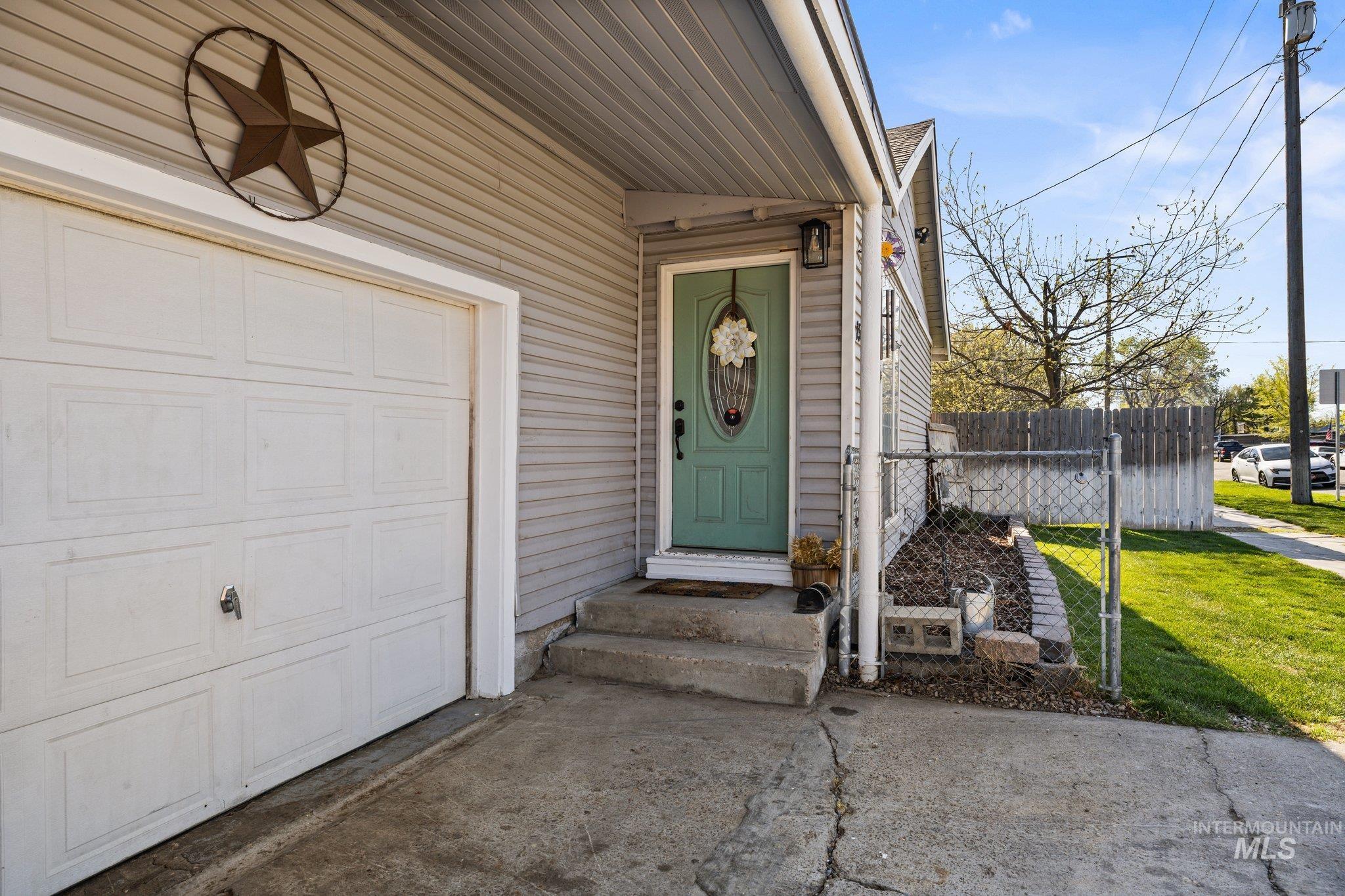 1504 2nd Street North Nampa, ID 83687 - Photo 3 of 29 Doorway to property with a garage and concrete driveway