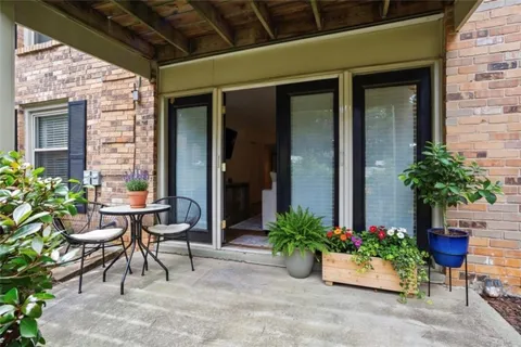 a view of a patio with a table and chairs in porch