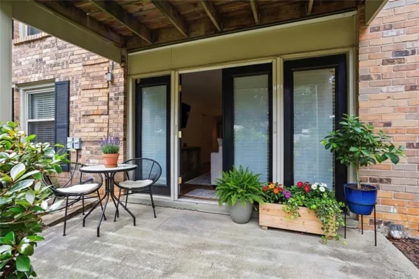 a view of a patio with a table and chairs in porch