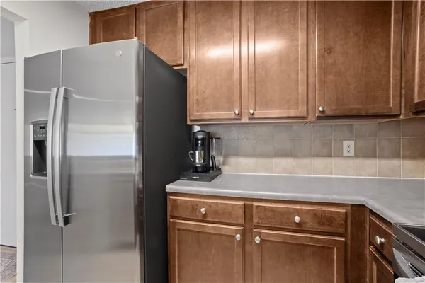 a kitchen with metallic refrigerator and cabinets