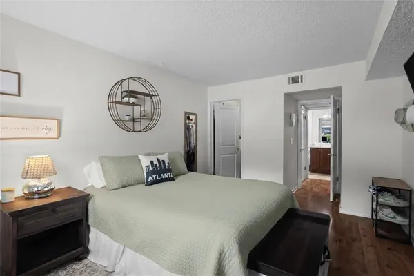 a bedroom with a bed and wooden floor
