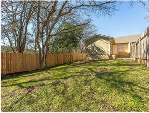 6403 Auburn Drive, Unit B Austin, TX 78723 - Photo 16 of 18 a view of a yard with an tree and wooden fence
