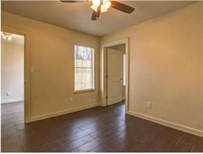 6403 Auburn Drive, Unit B Austin, TX 78723 - Photo 8 of 18 an empty room with wooden floor chandelier fan and windows