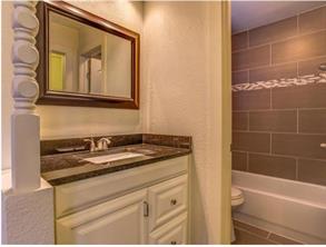 6403 Auburn Drive, Unit B Austin, TX 78723 - Photo 10 of 18 a bathroom with a granite countertop sink and a bathtub