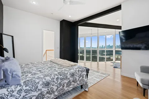 a bedroom with a bed and glass window