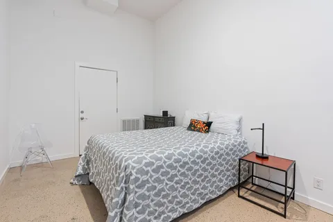 a bedroom with a bed and dresser