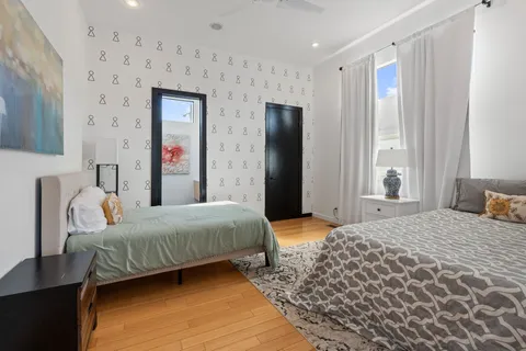 a bedroom with a bed and a large mirror