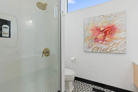 a bathroom with a toilet and a shower