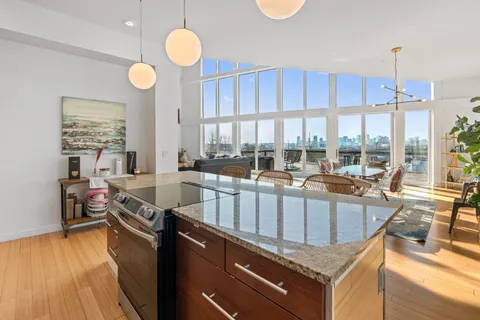 a very nice looking kitchen with a large window a counter space