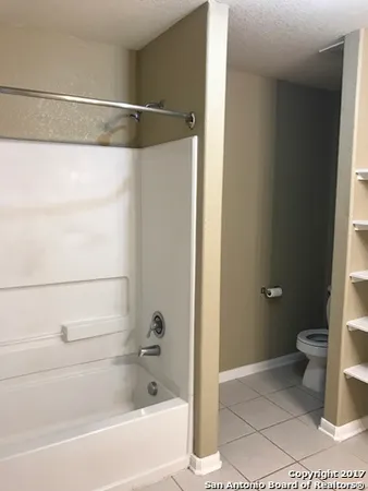a bathroom with a shower and a toilet