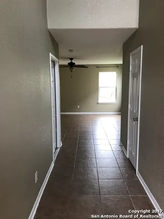 a view of hallway with a window and a refrigerator