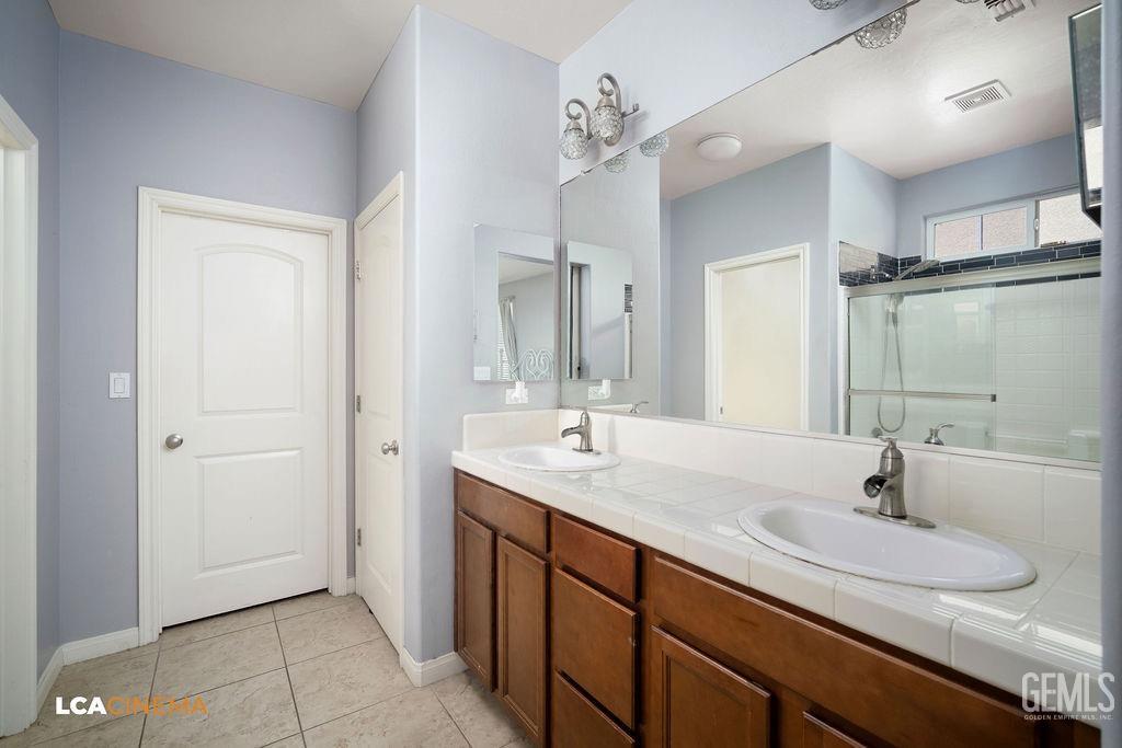 Undisclosed Address Bakersfield, CA 93314 - Photo 16 of 22 a bathroom with a sink double vanity and a mirror