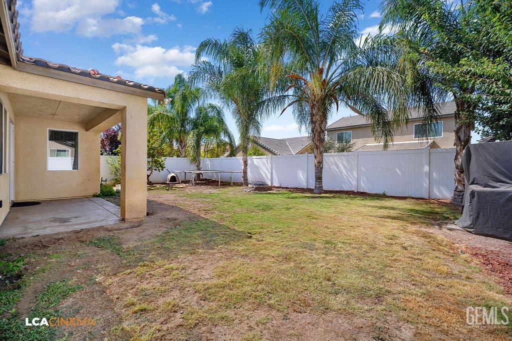 Undisclosed Address Bakersfield, CA 93314 - Photo 20 of 22 a couple of palm trees sitting in backyard of house