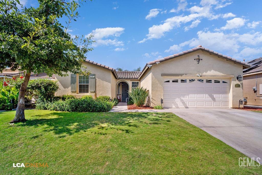 Undisclosed Address Bakersfield, CA 93314 - Photo 2 of 22 a front view of a house with a yard and garage