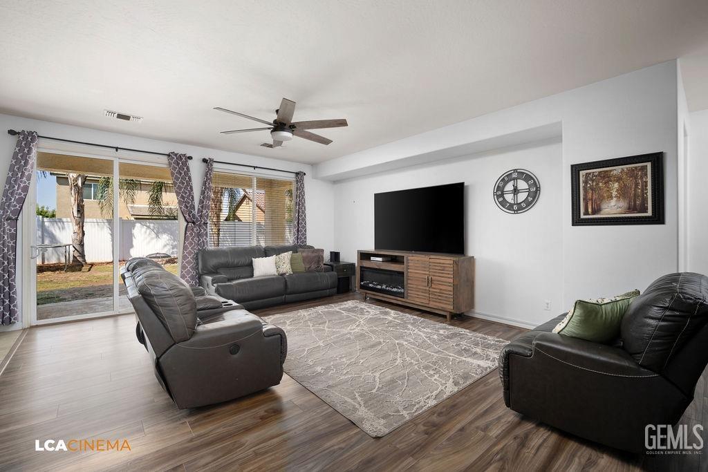 Undisclosed Address Bakersfield, CA 93314 - Photo 6 of 22 a living room with furniture and a flat screen tv