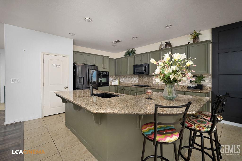 Undisclosed Address Bakersfield, CA 93314 - Photo 7 of 22 a kitchen with stainless steel appliances granite countertop table chairs and granite counter tops