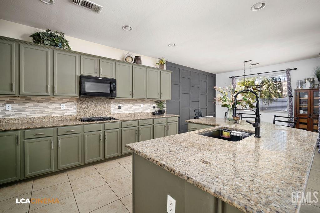 Undisclosed Address Bakersfield, CA 93314 - Photo 8 of 22 a kitchen with kitchen island granite countertop a sink a counter top space and cabinets