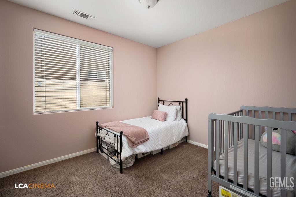 Undisclosed Address Bakersfield, CA 93314 - Photo 10 of 22 a bed room with a bed and a window