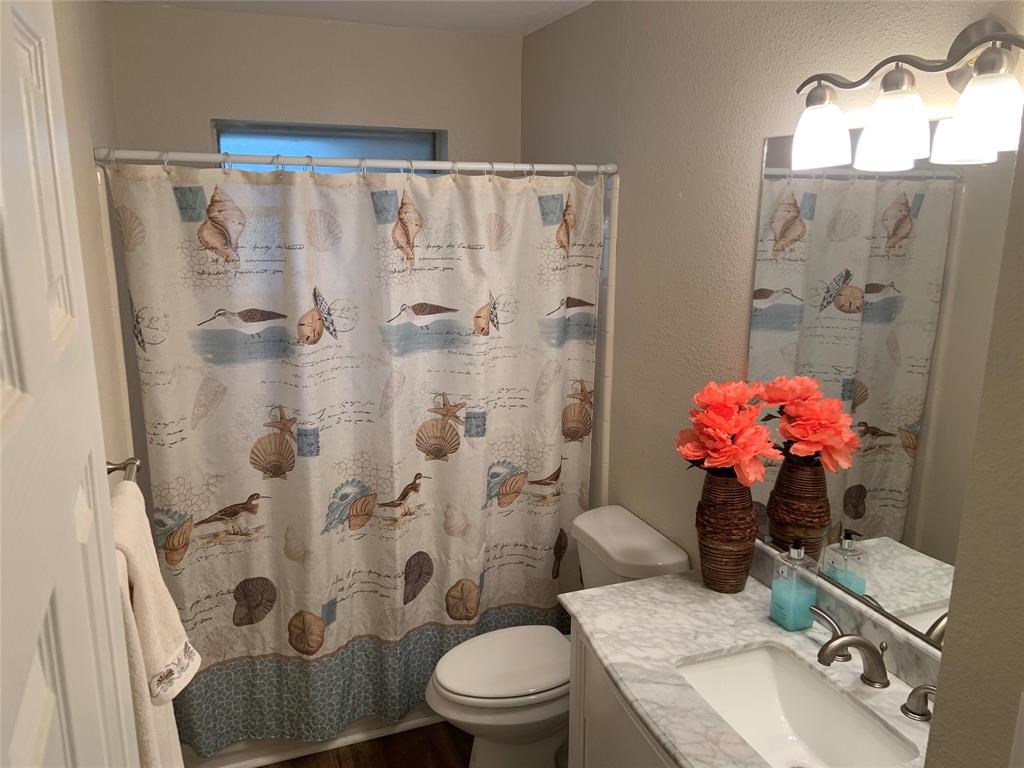 3302 Burke Road, Unit 9 Pasadena, TX 77504 - Photo 14 of 20 a bathroom with a sink toilet and shower
