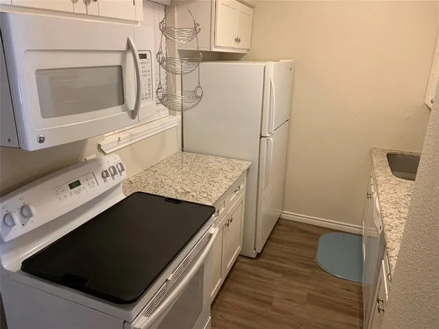 a kitchen with sink and cabinets