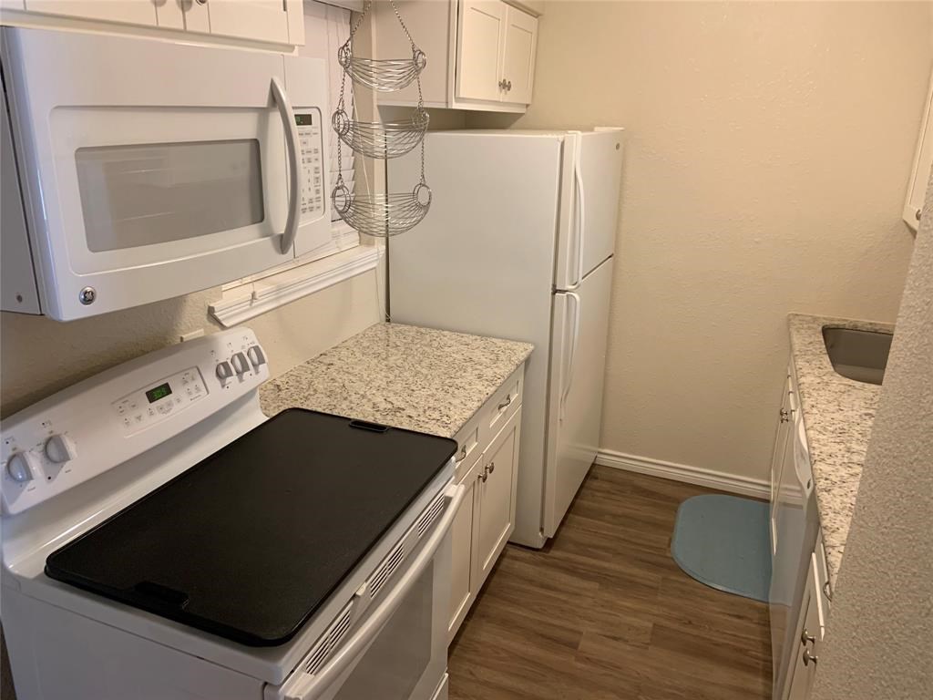 3302 Burke Road, Unit 9 Pasadena, TX 77504 - Photo 7 of 20 a kitchen with granite countertop a stove and a microwave