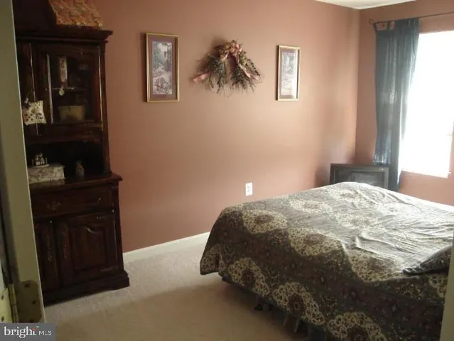 a bedroom with a bed and wall painting