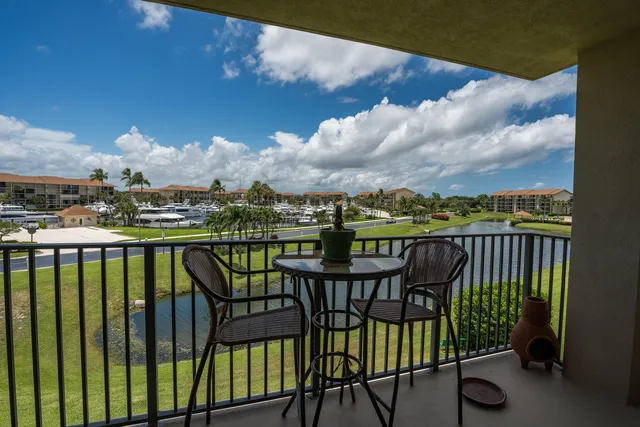 a view of a balcony with wooden chairs