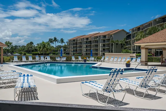 a view of house with swimming pool outdoor seating