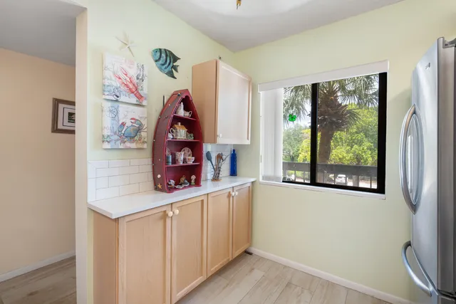 a room with a window and a painting on the wall