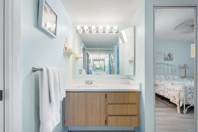a en suite bathroom with a sink a mirror and a bathtub