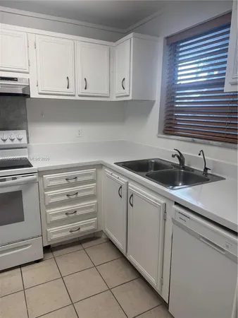 a kitchen with appliances cabinets and a sink