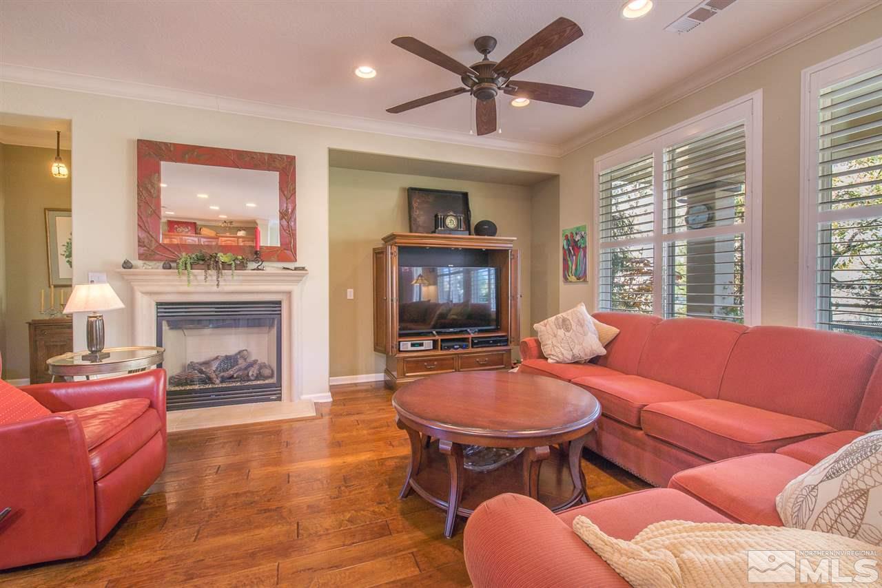 1480 Meridian Ranch Drive Reno, NV 89523 - Photo 8 of 19 a living room with furniture a fireplace and a large window