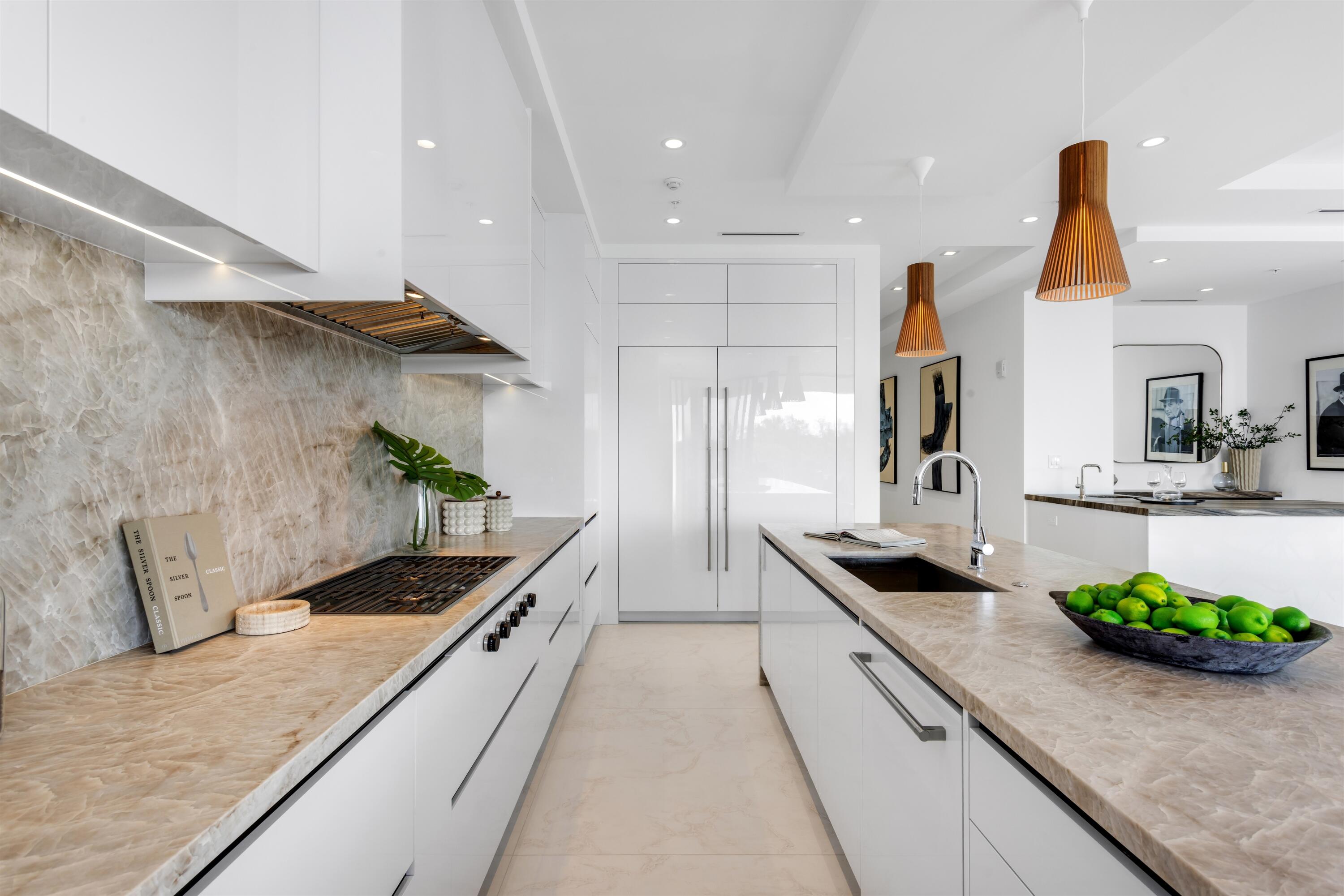 900 Lago Mar Lane, Unit PH Boca Raton, FL 33431 - Photo 14 of 58 a kitchen with stainless steel appliances kitchen island granite countertop a sink and a stove