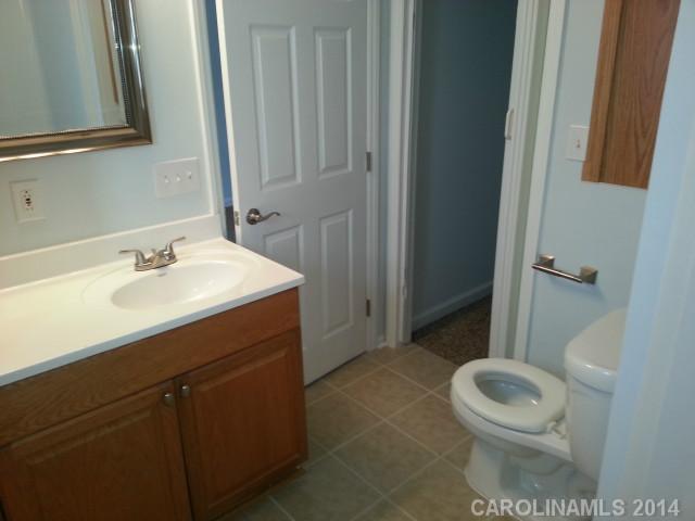 4605 Griffith Road Monroe, NC 28112 - Photo 13 of 16 a bathroom with a sink a toilet and a mirror