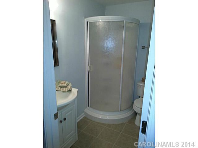 4605 Griffith Road Monroe, NC 28112 - Photo 14 of 16 a bathroom with a shower and a toilet