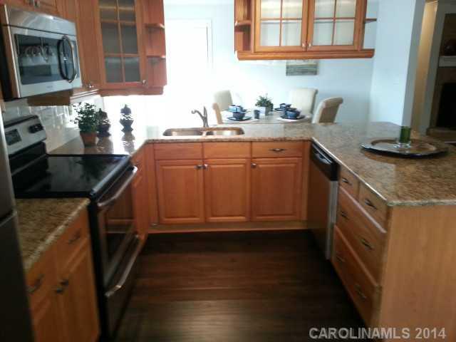 4605 Griffith Road Monroe, NC 28112 - Photo 3 of 16 a kitchen with granite countertop a sink stove and cabinets