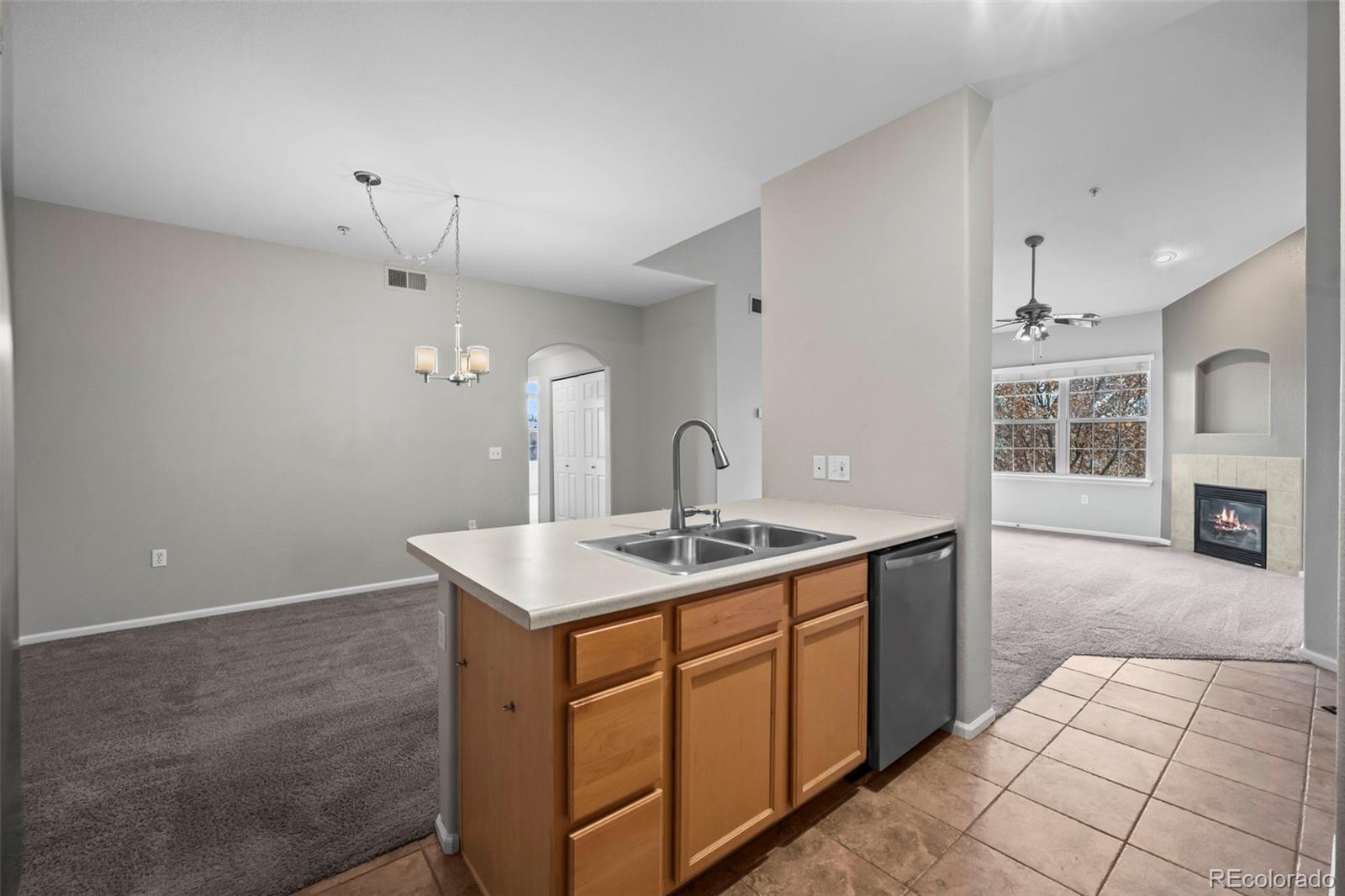 10787 Twenty Mile Road, Unit 301 Parker, CO 80134 - Photo 12 of 31 a kitchen with a sink and cabinets
