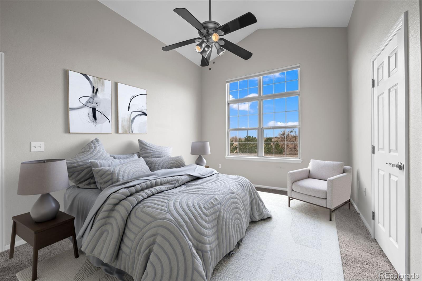10787 Twenty Mile Road, Unit 301 Parker, CO 80134 - Photo 13 of 31 a spacious bedroom with a bed and ceiling fan