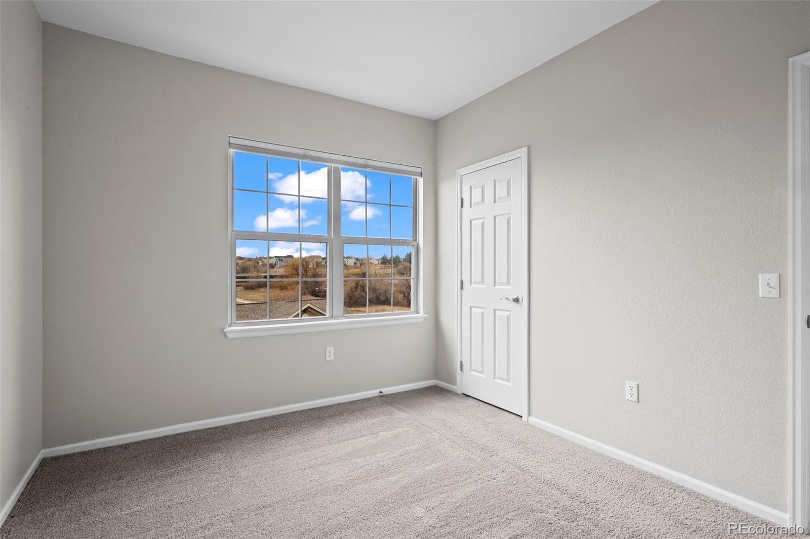 10787 Twenty Mile Road, Unit 301 Parker, CO 80134 - Photo 18 of 31 a view of an empty room with a window