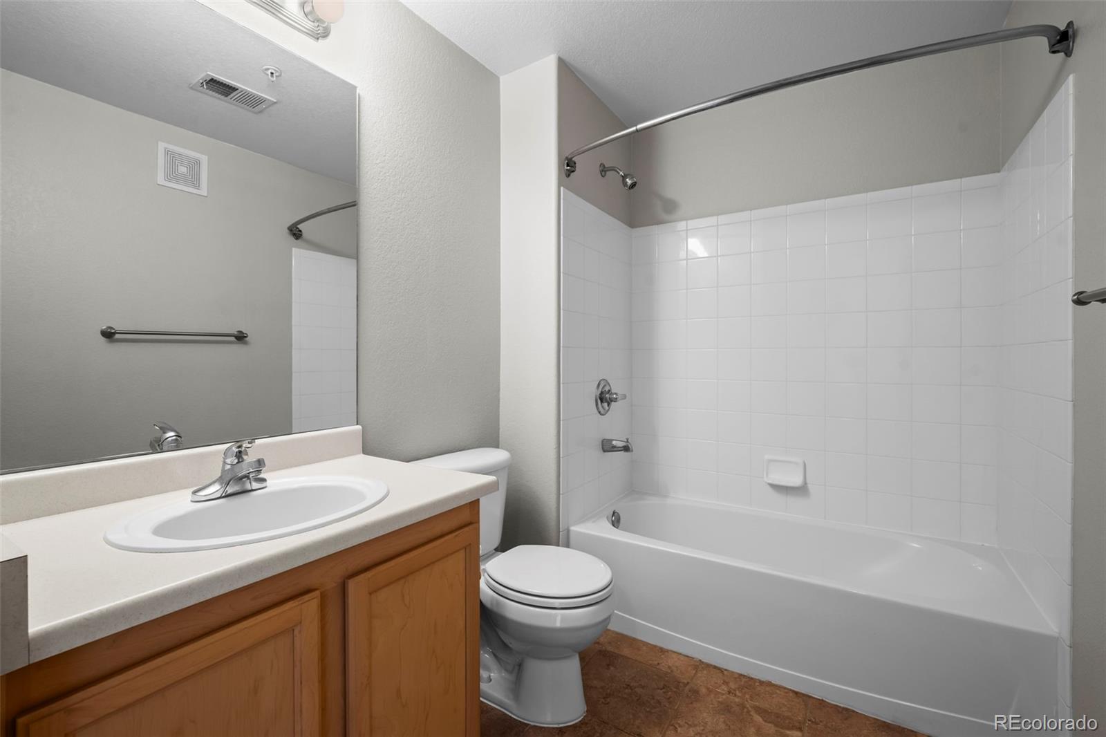 10787 Twenty Mile Road, Unit 301 Parker, CO 80134 - Photo 19 of 31 a bathroom with a sink a toilet and shower