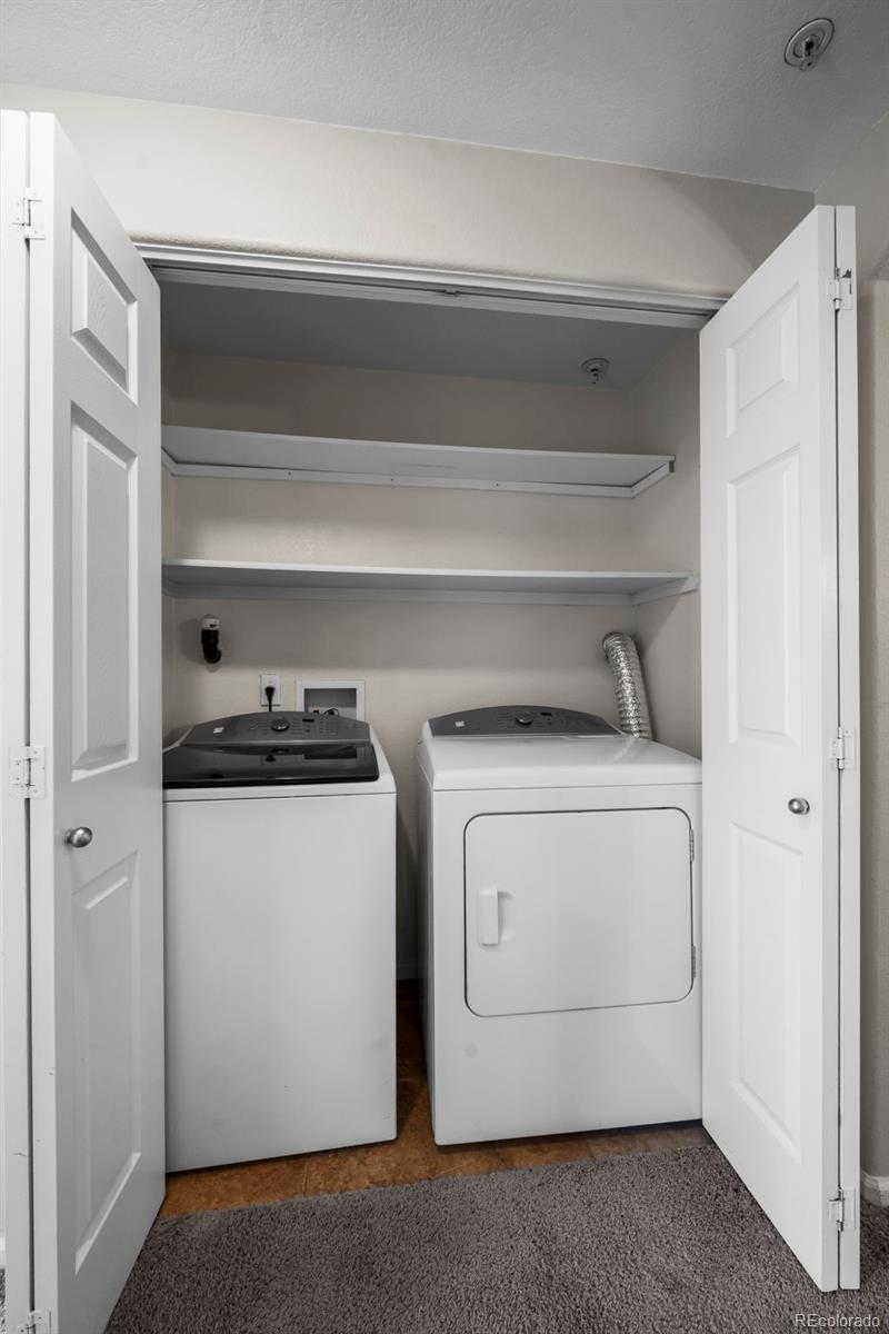 10787 Twenty Mile Road, Unit 301 Parker, CO 80134 - Photo 20 of 31 a utility room with dryer and washer