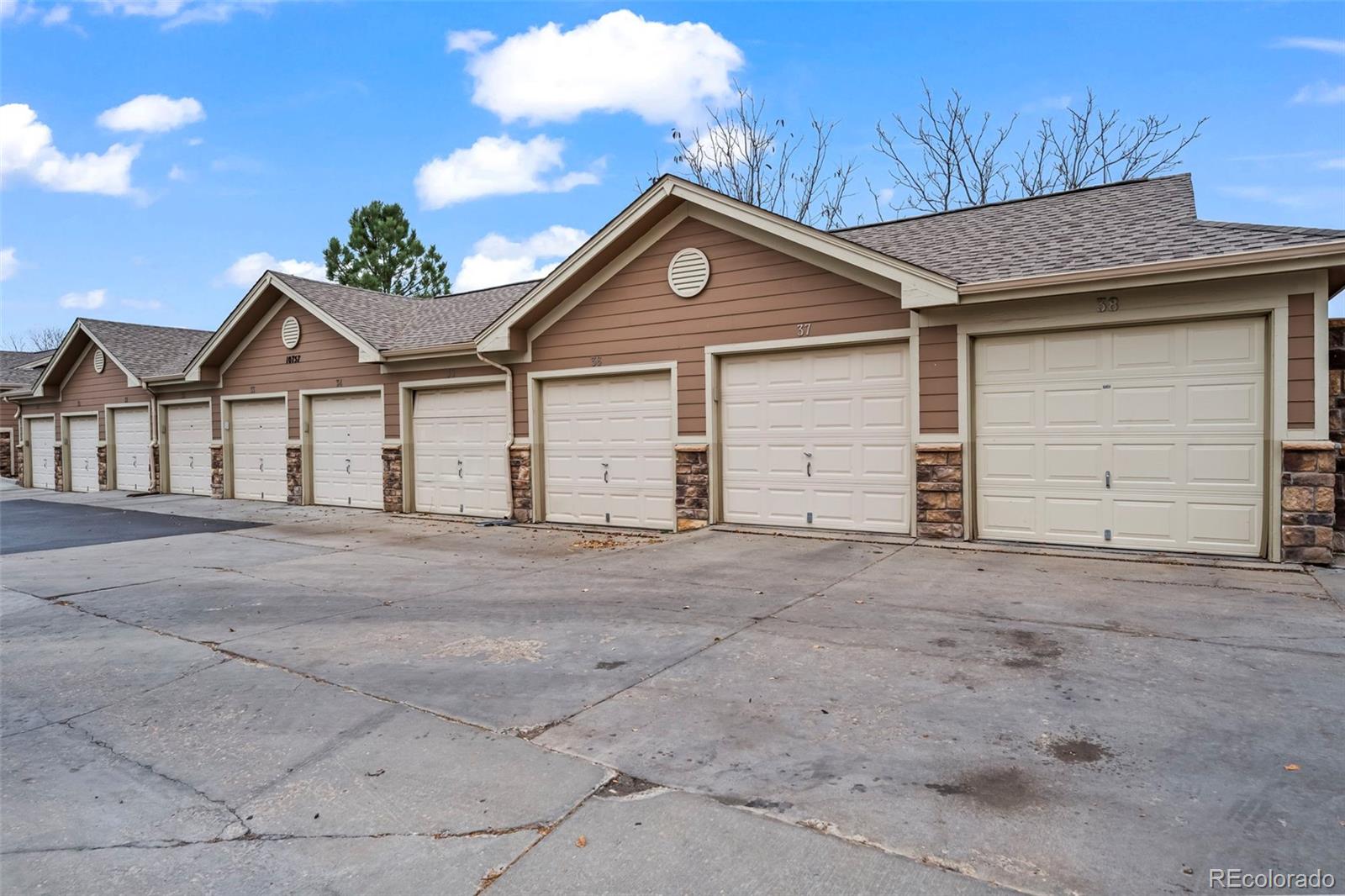 10787 Twenty Mile Road, Unit 301 Parker, CO 80134 - Photo 25 of 31 a view of garage and yard