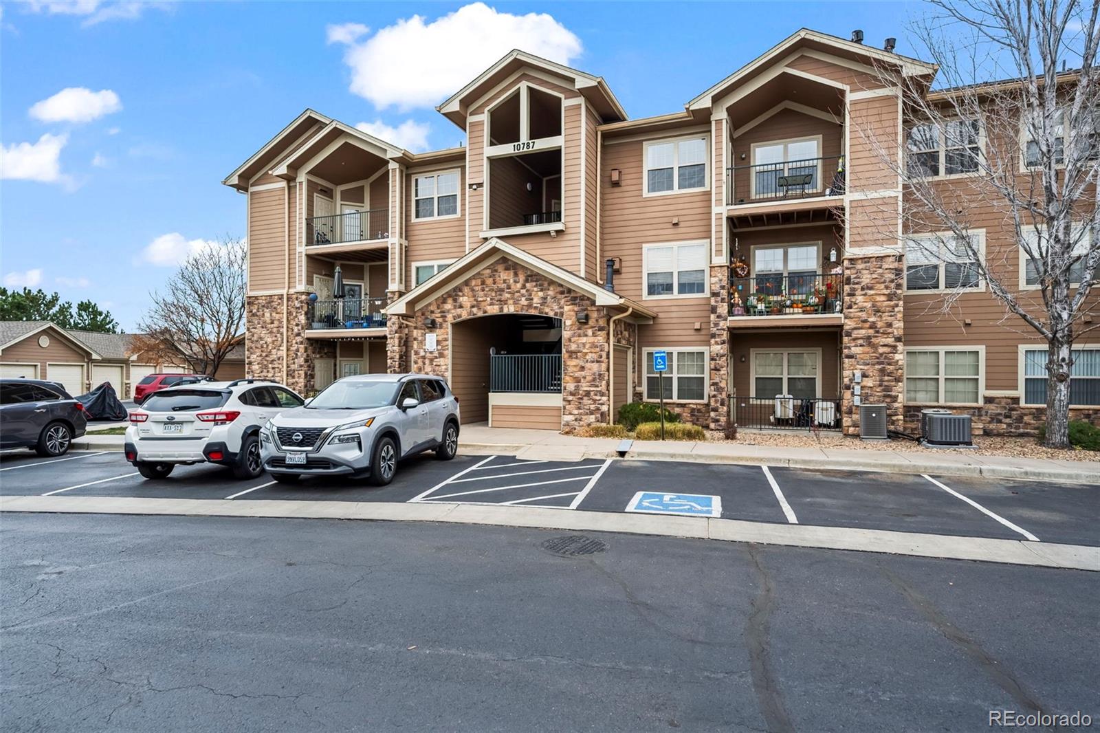 10787 Twenty Mile Road, Unit 301 Parker, CO 80134 - Photo 26 of 31 a front view of a house with parking space